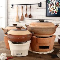 pots and pans sitting on top of a wooden table