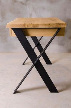 a wooden table with black metal legs