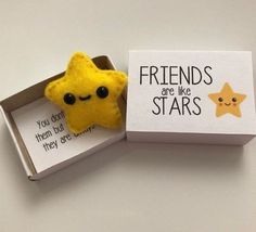 a small yellow star in a box with a card saying friends are like stars