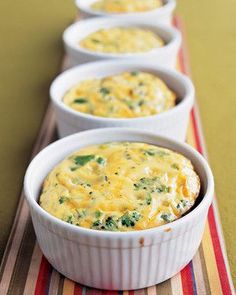 two white bowls filled with broccoli and cheese