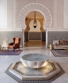 the lobby is decorated in white and features an intricately designed fountain with lights on it