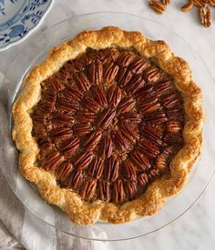 a pecan pie on a glass plate