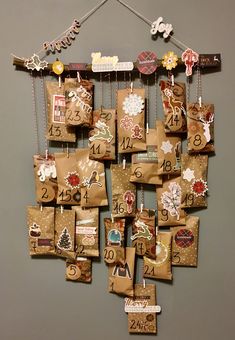 a clock made out of brown paper bags with numbers on them and christmas decorations hanging from strings