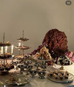 a table topped with lots of different types of desserts