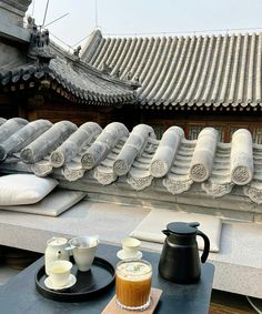 there are two cups on the table next to each other with tea and coffee in front of them