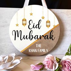 a sign that reads, eid mubarak the khan family on it