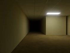 an empty room with light coming from the ceiling