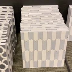 several stacks of white and grey boxes on the floor