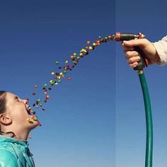 two pictures of a child being held up by a hose with colorful balls coming out of it