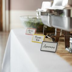 there is a table set up with place cards on it for guests to sit at