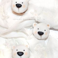 two white teddy bears sitting next to each other on top of a bed covered in white sheets