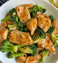 a white bowl filled with chicken and broccoli