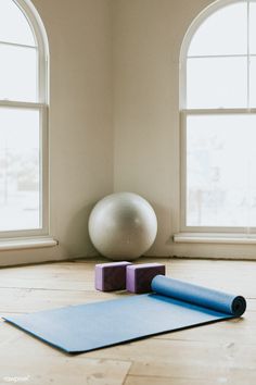 a yoga mat and two windows in a room