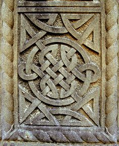 an intricate design is shown on the side of a stone wall in a medieval style