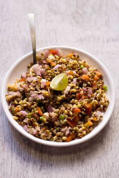 a white bowl filled with food on top of a table