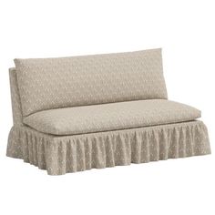 a couch with a ruffled skirt on it's back and the seat upholstered