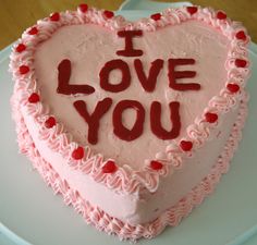 a heart shaped cake with the words i love you written on it