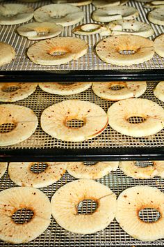 several trays filled with donuts on cooling racks