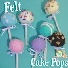 four cake pops with frosting and sprinkles are on a blue background