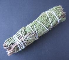 a roll of white string sitting on top of a blue surface