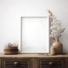 a white frame sitting on top of a wooden dresser next to a vase with flowers