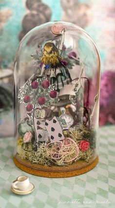 a glass cloche with an image of a cow under it on a checkered table cloth