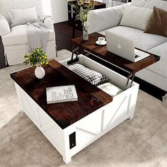 a living room filled with furniture and a laptop computer on top of a coffee table