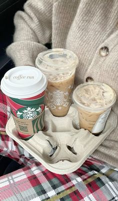 two cups of coffee are sitting on a tray