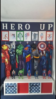 there are many superheros on the shelf in this boys's room, including captain america and iron man