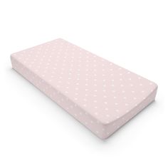 a pink mattress with white polka dots on it