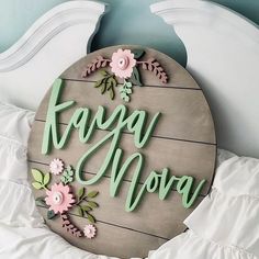 a wooden sign that says faggu mova on the side of a bed