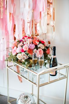 a table with flowers and champagne on it