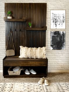 a wooden bench sitting in front of a white brick wall with shoes on the floor