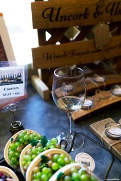 grapes in baskets and wine glasses on a table