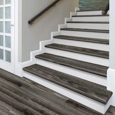 the stairs are made of wood and have white railings