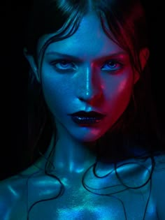 a woman with blue and red light on her face