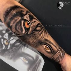 an arm with a tiger's eyes and the image of a woman on it