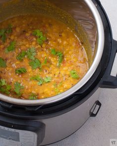 a pot filled with food sitting on top of a stove