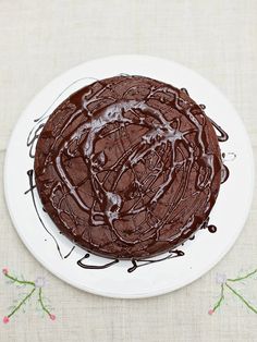 a chocolate cake sitting on top of a white plate