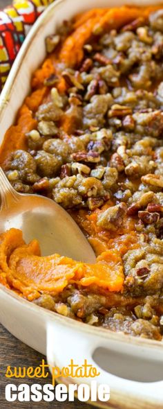 sweet potato casserole in a white dish with a wooden spoon on the side