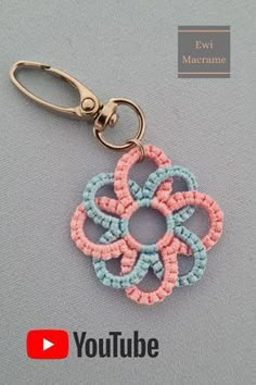 a keychain with an embroidered flower on it