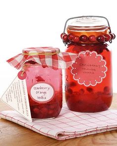 there is a jar of cranberry orange jelly next to a small container of cherries