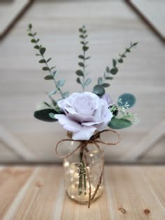 a vase filled with flowers on top of a wooden table