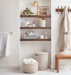 the bathroom is clean and ready to be used as a place for towels, soaps, and other things