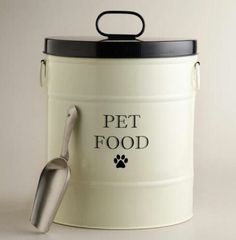 a canister with a spoon in it and the words pet food written on it