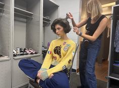 a woman getting her hair cut in a dressing room