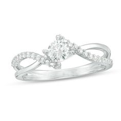 a white gold ring with an oval cut diamond in the center