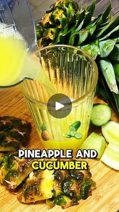 pineapple and cucumber juice being poured into a glass on a cutting board