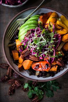 a salad with carrots, black beans and avocado