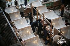 an overhead view of people shopping in a store filled with shelves and boxes full of items